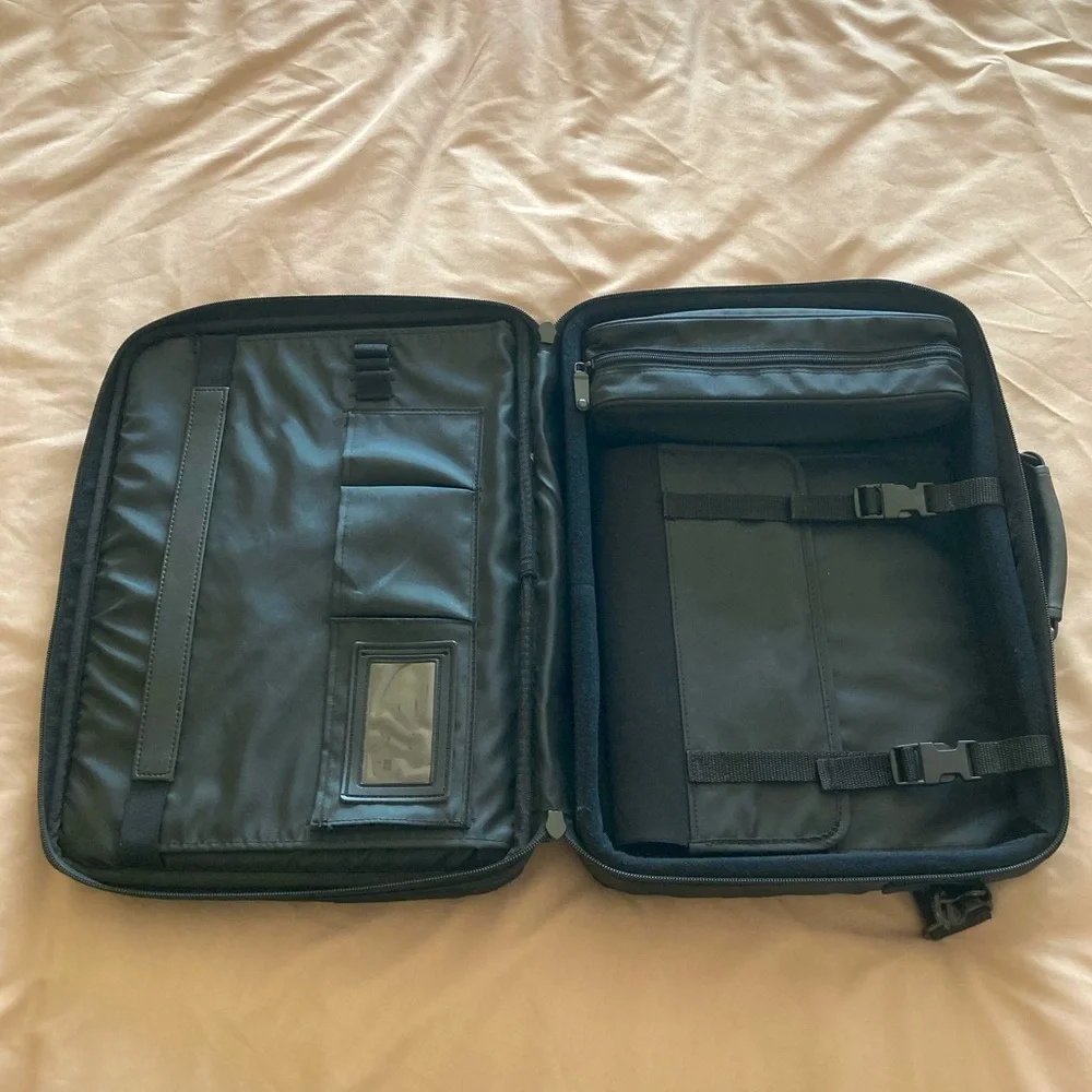 Gently used laptop bag in black nylon with several compartments.